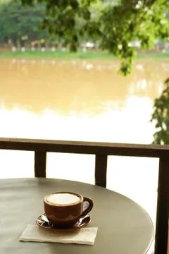 Coffee cup at riverside view Stock Photos