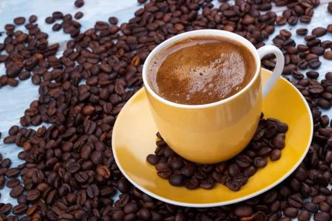Coffee cup with roasted beans Stock Photos