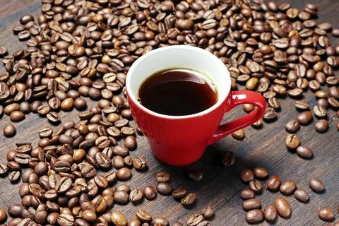 Coffee cup with roasted coffee beans on wooden table. View from top Stock Photos
