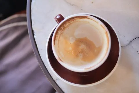 Coffee cup sits empty on a table after morning drink Stock Photos