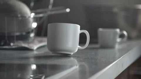 Coffee Cup Spinning Around on Kitchen Table Stock Footage 145112985