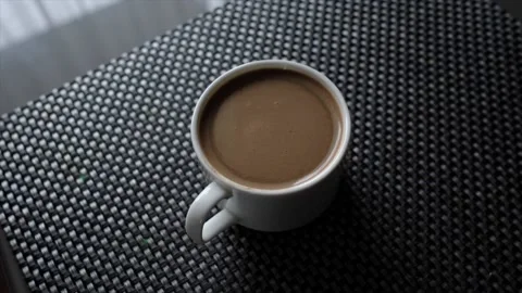 Coffee in a cup is spinning in a circle. Stock Footage 176502076