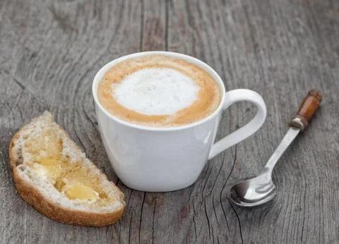 Coffee cup, spoon and bread with honey Stock Photos
