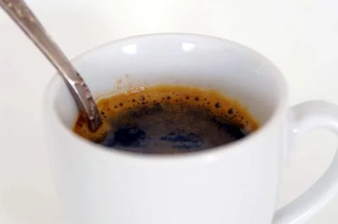 Coffee cup with a spoon, isolated Stock Photos