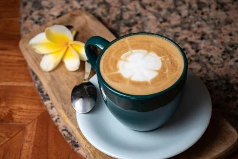 Coffee cup on stone kitchen table. Cappuccino, hot latte or coffee with milk. Stock Photos