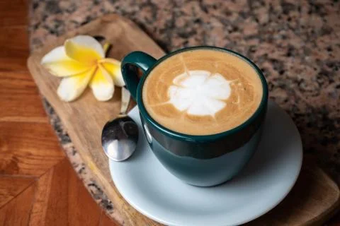 Coffee cup on stone kitchen table. Cappuccino, hot latte or coffee with milk. Stock Photos