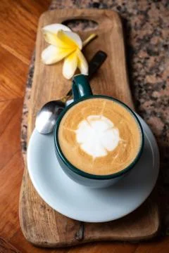 Coffee cup on stone kitchen table. Cappuccino, hot latte or coffee with milk. Stock Photos