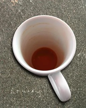 Coffee cup on a stone slab, except for a small rest empty drink Stock Photos