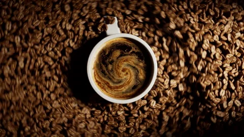 Coffee cup surrounded by spinning roasted beans. Stock Footage 328628404