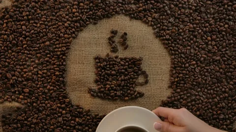 Coffee cup symbol drawn with roasted arabica turns into real cup with espresso Stock Footage 138523319
