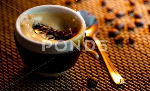 Coffee cup on the table with beans Stock Photos