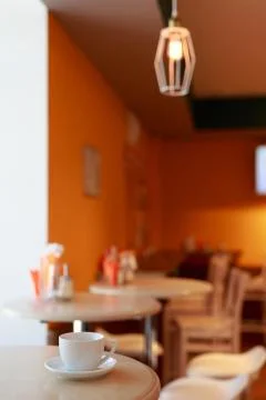 Coffee Cup is on the table in a cafe with a blurry background Stock Photos