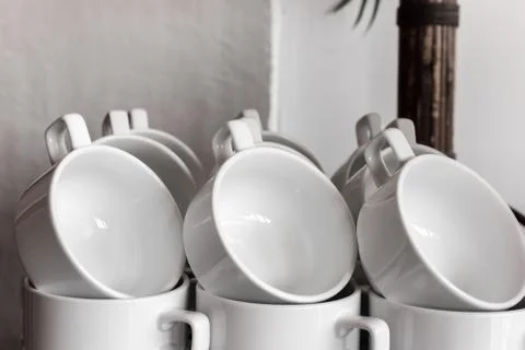 Coffee cup on the table in coffee room at hotel in the morning. Stock Photos