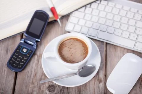 Coffee Cup on the Table with Computer Keyboard for Business Concept Stock Photos