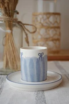 Coffee cup on a table with decorations and plants Stock Photos