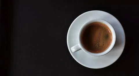 The coffee cup is on the table. It's hot. Stock Photos