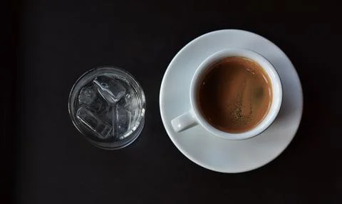 The coffee cup is on the table. It's hot. Stock Photos
