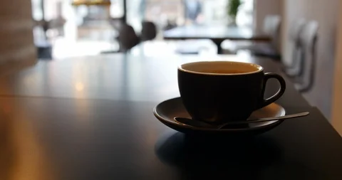 Coffee cup on the table in lounge bar background. Video stock 122818238
