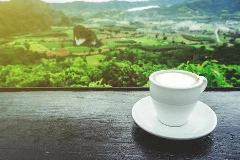 Coffee cup on table with Mountain views in the morning as a background Stock Photos