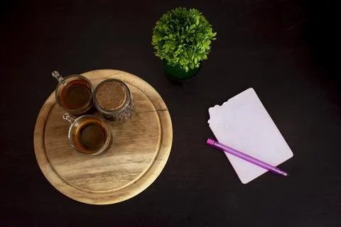 Coffee cup on the table, with pen,Black background Stock Photos
