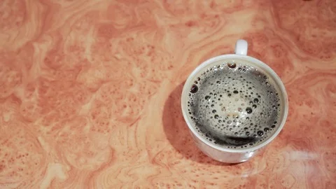 The coffee Cup is on the table. The view from the top. Stock Footage 123173000