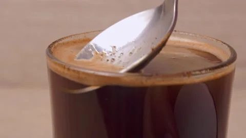 Coffee in the cup - taking off foam with spoon Stockbeeldmateriaal 139355331