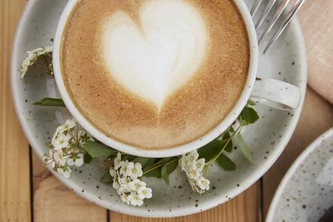 Coffee cup top view close up. Creamy cappuccino with heart shape foam. Mock up Stock Photos