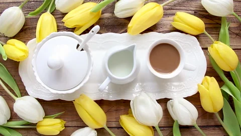Coffee cup on a tray between tulips top view Stock Footage 150875892