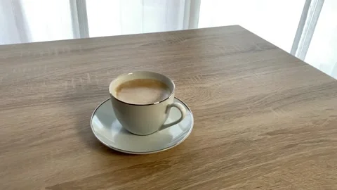Coffee cup with two sugar cubes falling into it in slow motion Stock Footage 155010674