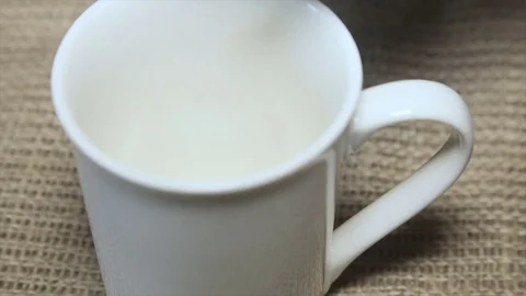 A coffee cup in a white powder Stock Footage 71927917