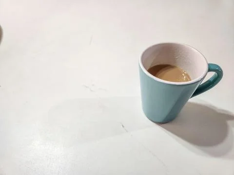 Coffee cup on a white table. Stock Photos