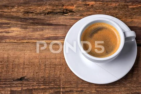 Coffee cup on a wooden table. Dark background Stock Photos