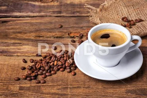 Coffee cup on a wooden table. Dark background Stock Photos