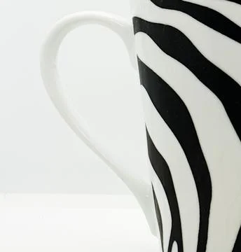 A coffee cup with zebra line pattern 스톡 사진