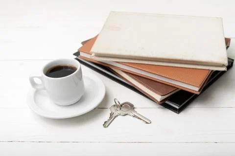 Coffee cup,key and stack of book Stock Photos