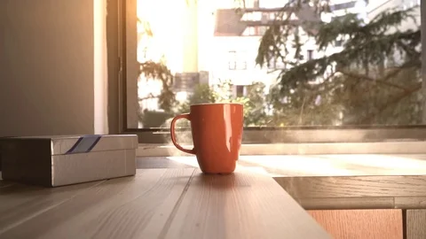 Coffee cups and chocolates in front of the window. Stock Footage 82688004