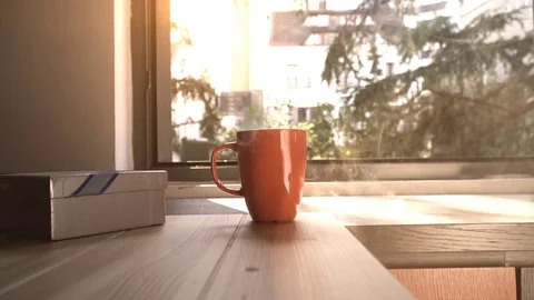 Coffee cups and chocolates in front of the window. Stock-Footage 82688032