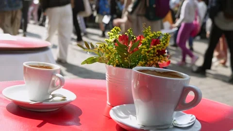 Coffee cups and flowers on table at Paris outdoor cafe Stock Footage 311321661