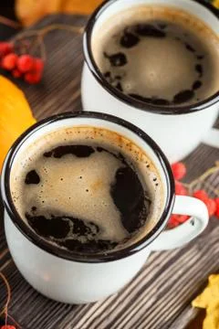 Coffee cups and pumpkins Stock Photos