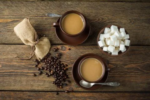 Coffee cups, beans and sugar Stock Photos