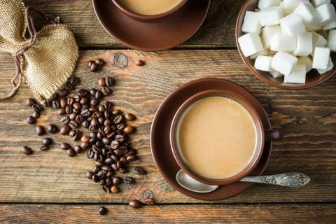 Coffee cups, beans and sugar Stock Photos