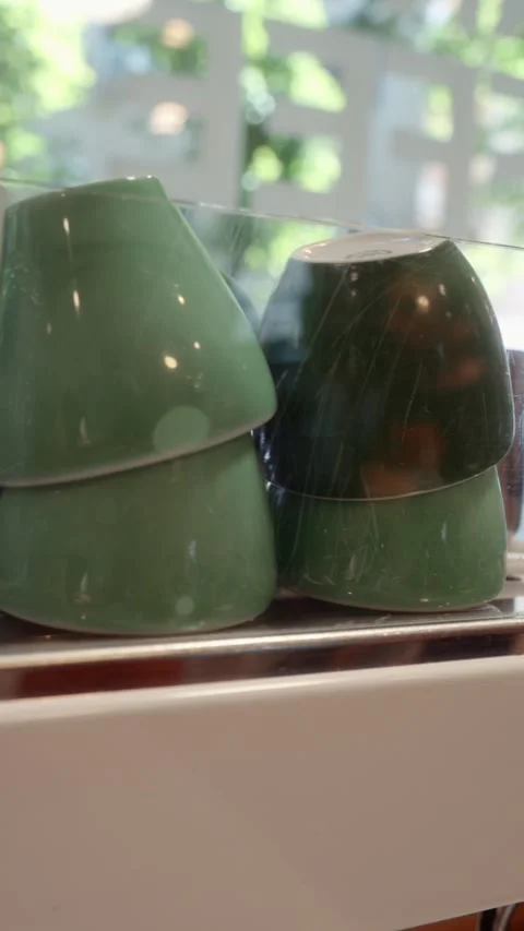 Coffee Cups Displayed Upside Down in Glass Showcase Stock Footage 339275527