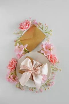 Coffee Cups, Gift Box, Envelope and Pink Flowers in Shape of Eight. Elegant.. Stock Photos