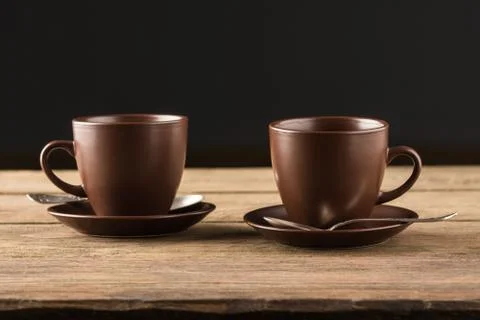 Coffee cups on rustic wooden table Stock Photos