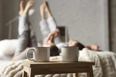 Coffee cups table with couple bed. High quality photo Stock Photos