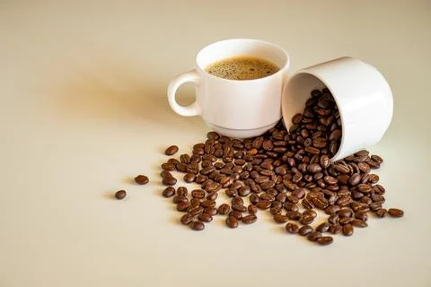 Coffee cups on off white background  full of coffee beans and coffee drink Stock Photos