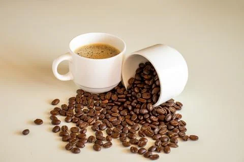 Coffee cups on off white background  full of coffee beans and coffee drink Stock Photos