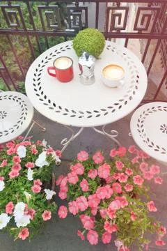 Coffee cups on white table on balcony outdoors Stock Photos