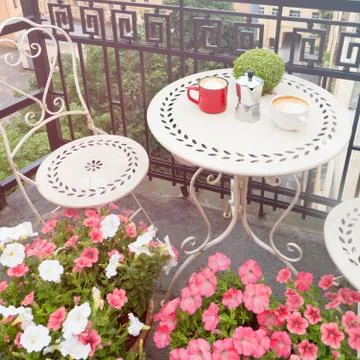 Coffee cups on white table on balcony outdoors Stock Photos