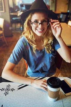Coffee a day keeps the grumpy away. a female hipster in a coffee shop. Stock Photos